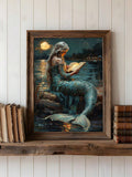 Teal mermaid reading by moonlit water in a framed gothic bookish portrait display