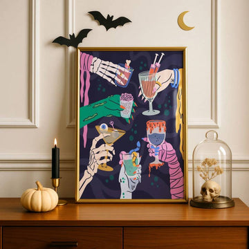Gothic Halloween cocktail artwork framed beside a pumpkin, candle, bats, and skull