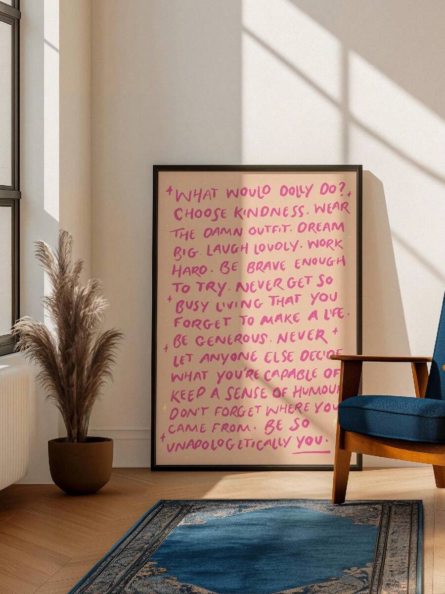 Framed pink handwritten “What Would Dolly Do?” quote poster beside a blue chair