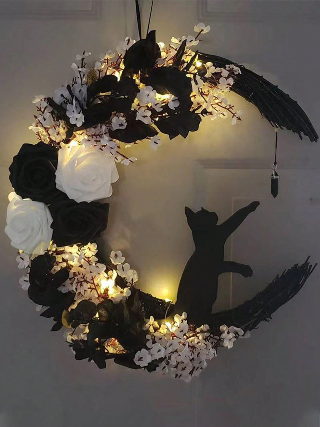 Expertly handcrafted, this black branch wreath brings a spooky touch to your Halloween decor. Perfect for both indoor and outdoor parties, its unique design adds a rustic yet eerie vibe to your space. Get ready to impress guests with this one-of-a-kind decoration.
