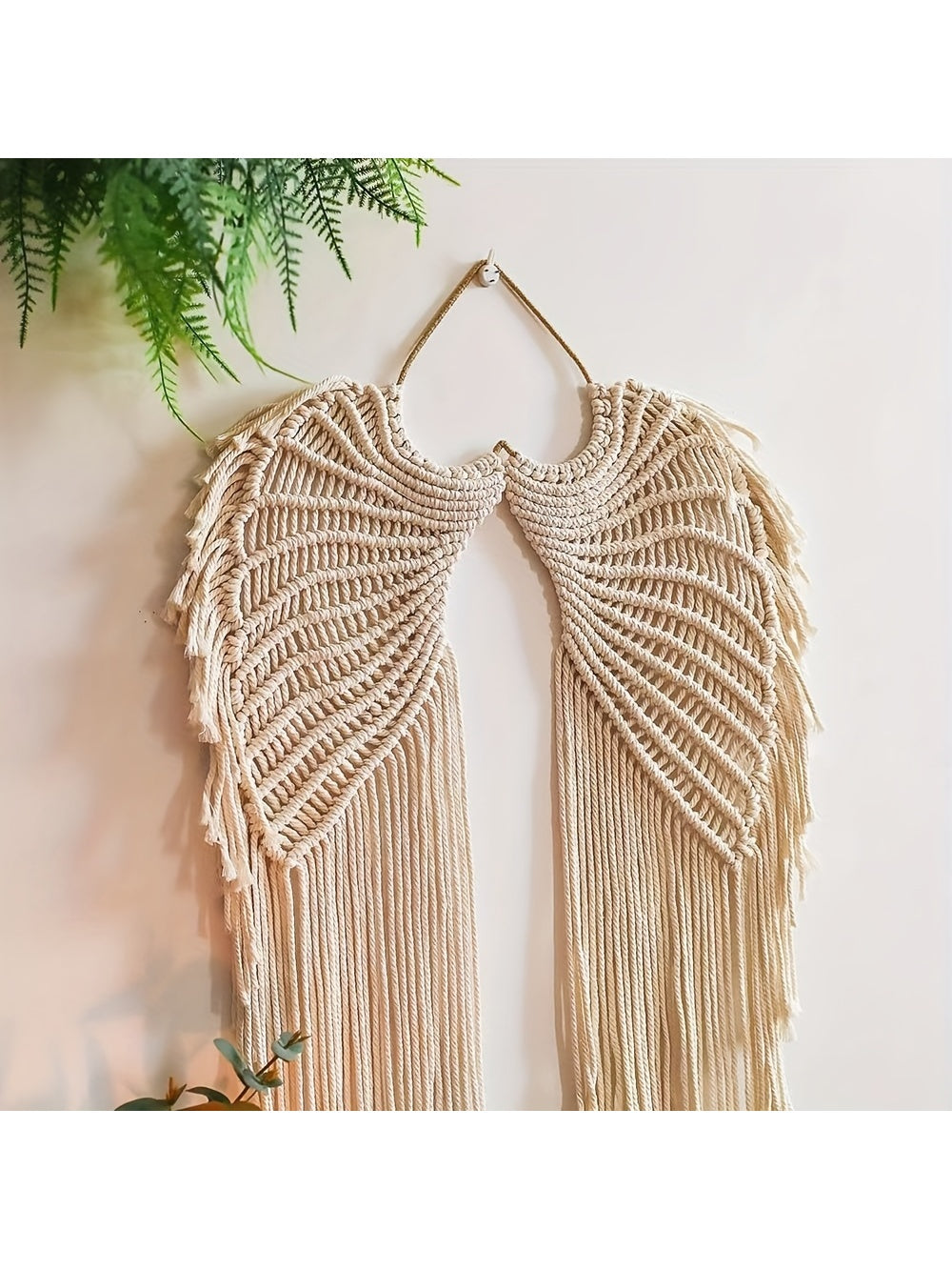 Expertly crafted and uniquely designed, our Heavenly Wings Macrame Wall Hanging Tapestry brings a touch of bohemian charm to any room. Made with intricately woven macrame, this handcrafted décor piece adds texture and style to your walls. Elevate your home décor with this versatile and timeless tapestry.