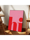 Pink red hi typography canvas leaning on floor beside wooden chair