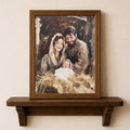 Holy Family nativity canvas poster in a warm wood frame above a rustic shelf