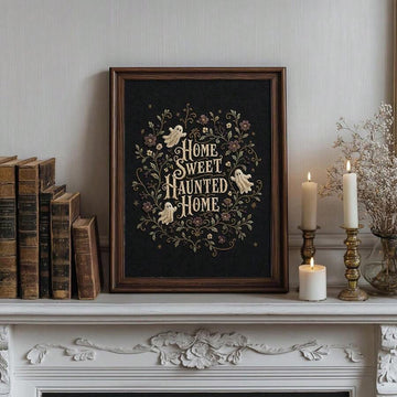 Framed Home Sweet Haunted Home ghost floral art on a mantel with candles