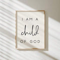 Framed I Am a Child of God print on a sunlit cream wall