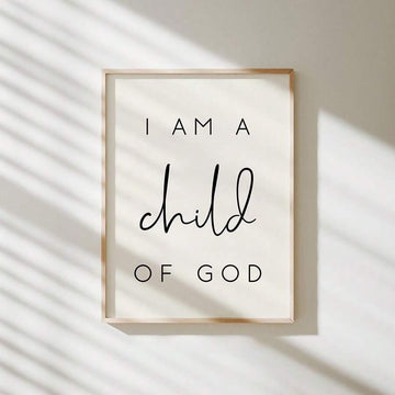 Framed I Am a Child of God print on a sunlit cream wall
