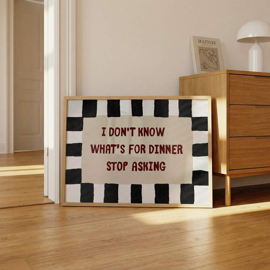 Framed I Don't Know What's for Dinner Stop Asking quote poster beside wood dresser in sunlit room
