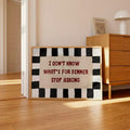 Framed I Don't Know What's for Dinner Stop Asking quote poster beside wood dresser in sunlit room