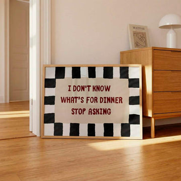 Framed I Don't Know What's for Dinner Stop Asking quote poster beside wood dresser in sunlit room