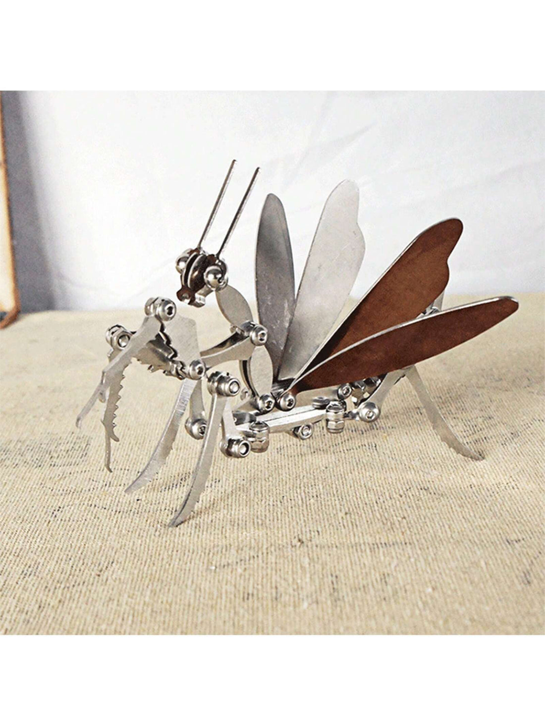 Bring a touch of elegance to your home decor with our Intricate 3D Metal Mantis Model. Made of high-quality stainless steel, this ornament showcases a beautifully detailed design of a mantis that will add a unique and sophisticated touch to any room. Perfect for insect enthusiasts and a thoughtful gift for any occasion.