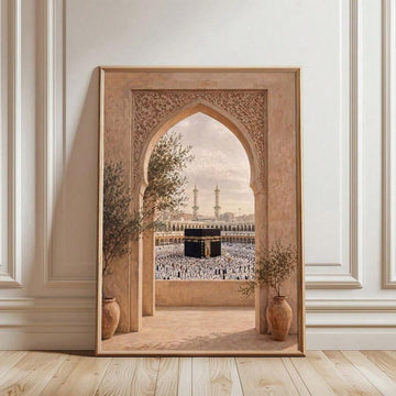 Warm framed Kaaba artwork with worshippers and twin minarets viewed through an ornate arch between potted trees