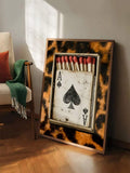 Leopard wall art ace of spades matchbox print leaning in warm room with red matches