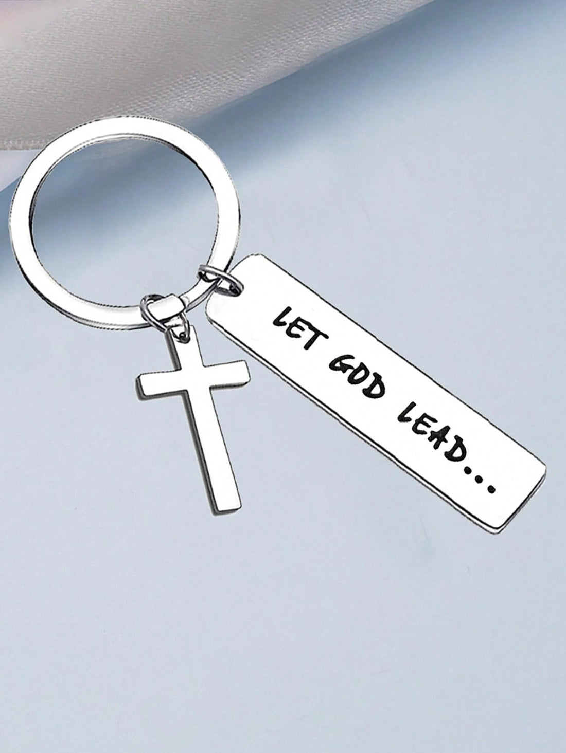Let God guide your path with our Let God Lead Cross Keychain. This inspirational Christian gift can be attached to your wallets, bags, or backpacks as a reminder to trust in His plan. Crafted with care, this keychain is a perfect accessory for any religious individual.