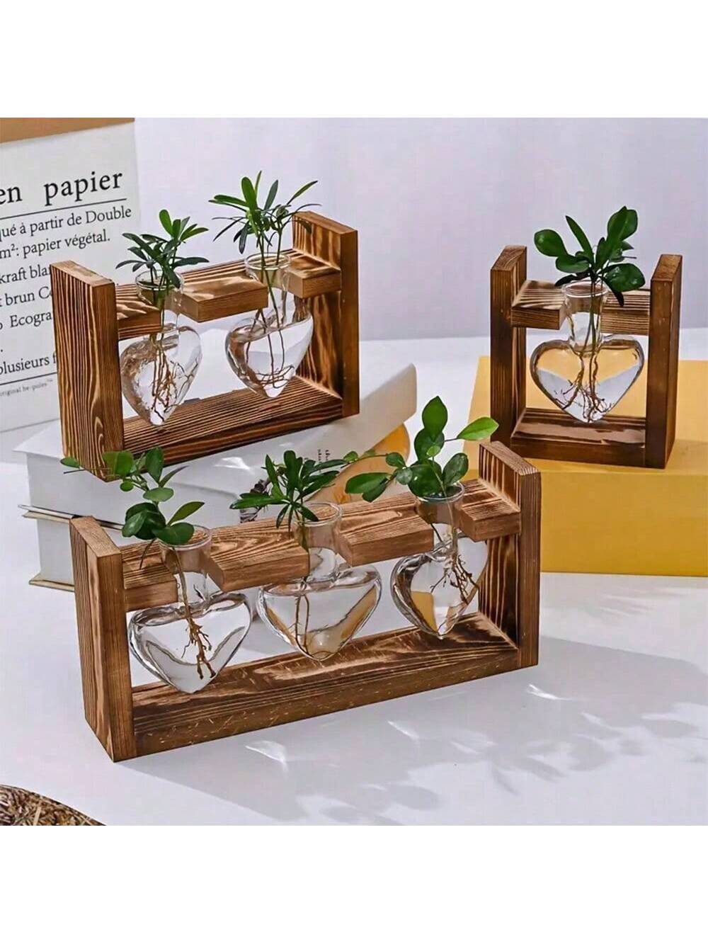 Introducing Love Grows Here, the Heart Vase Hydroponic Plant Terrarium with Wooden Stand. Add a touch of love and greenery to your space with this stunning terrarium. The heart-shaped vase and wooden stand create a unique and eye-catching display for your favorite plants.