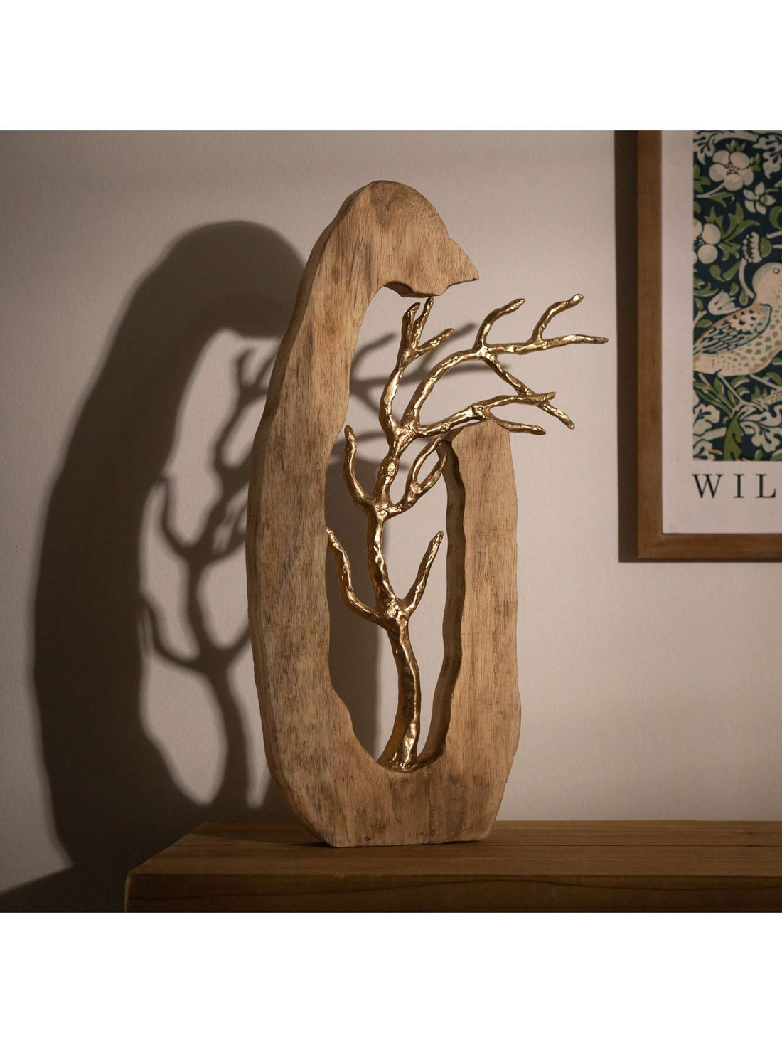 With a blend of mango wood and metal, this tree disc sculpture adds a touch of rustic elegance to any home decor. Expertly crafted, this unique piece will make a statement in any room. Add a natural and sophisticated element to your space with this handcrafted sculpture.