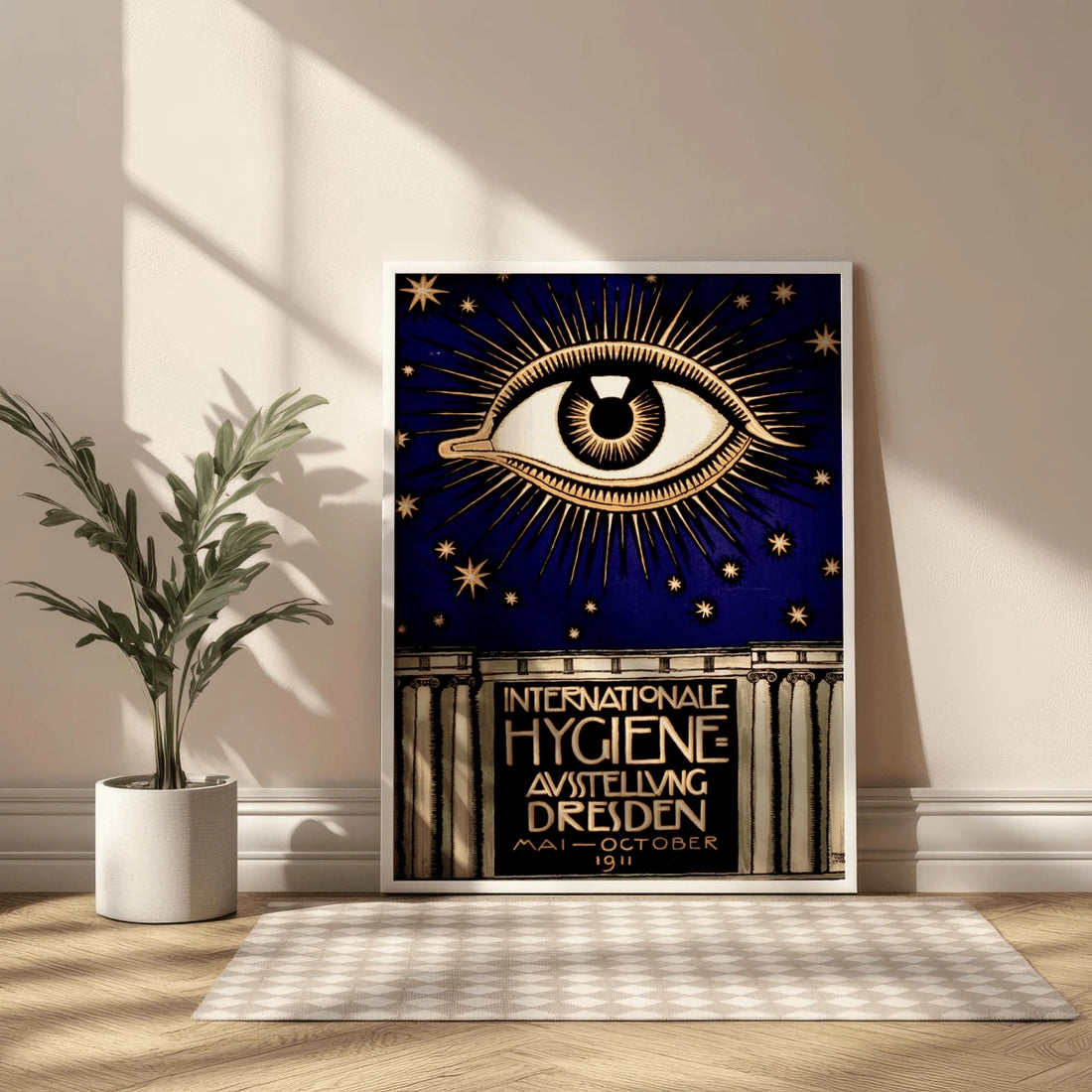 Framed navy and gold Dresden exhibition eye poster leaning beside a potted plant
