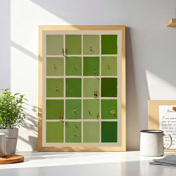 Light wood framed green grid artwork above a sunlit white desk