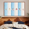 Six tiny surfers on colorful boards across blue and cream bands in canvas print