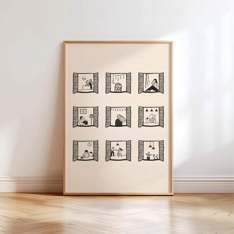 Framed ivory print with nine black line-art window scenes leaning against a white wall