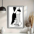 Black-and-white embracing couple and cat line art shown above a styled console