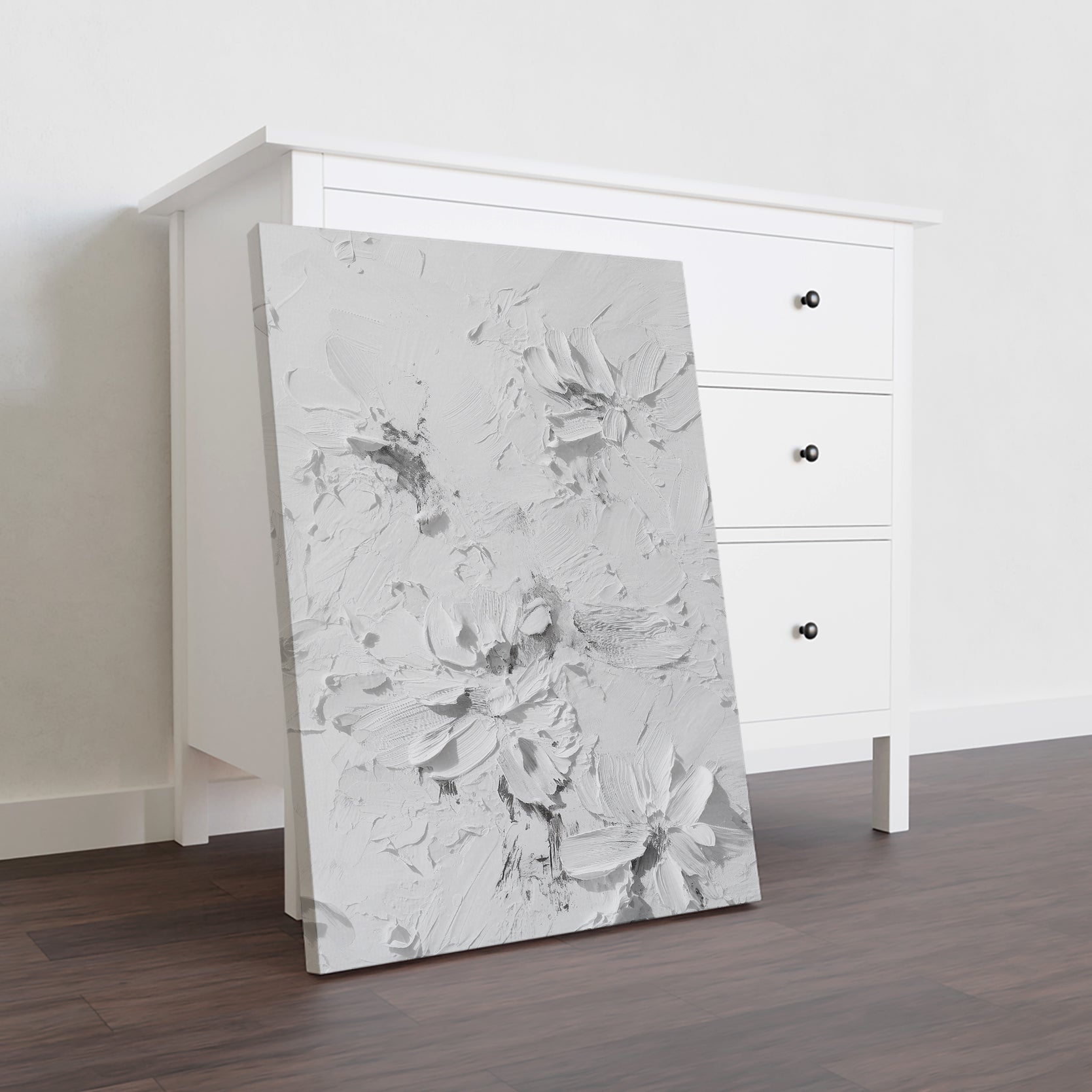 Elevate your interior with this contemporary canvas art piece, featuring delicate floral motifs rendered in sophisticated white tones against a textured background. The dimensional surface adds depth and visual interest, creating a refined focal point that complements modern and transitional décor styles. Versatile enough for living rooms, bedrooms, or entryway spaces, this artwork brings understated elegance to any wall.