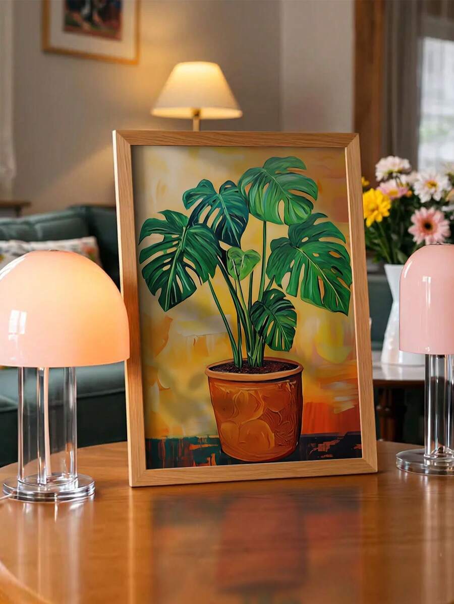 Monstera botanical canvas in terracotta pot styled with warm table lamps
