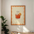 Framed Negroni cocktail poster with orange scalloped border and black handwritten title in a dining nook