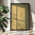 Botanical branch silhouette canvas print in olive ochre and black above a neutral sunlit wall