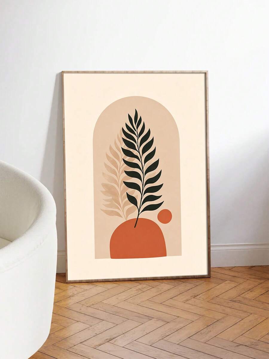 Framed fern canvas print with terracotta shapes beside a white chair