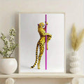 Framed yellow leopard and pink pole canvas poster on a decorative shelf