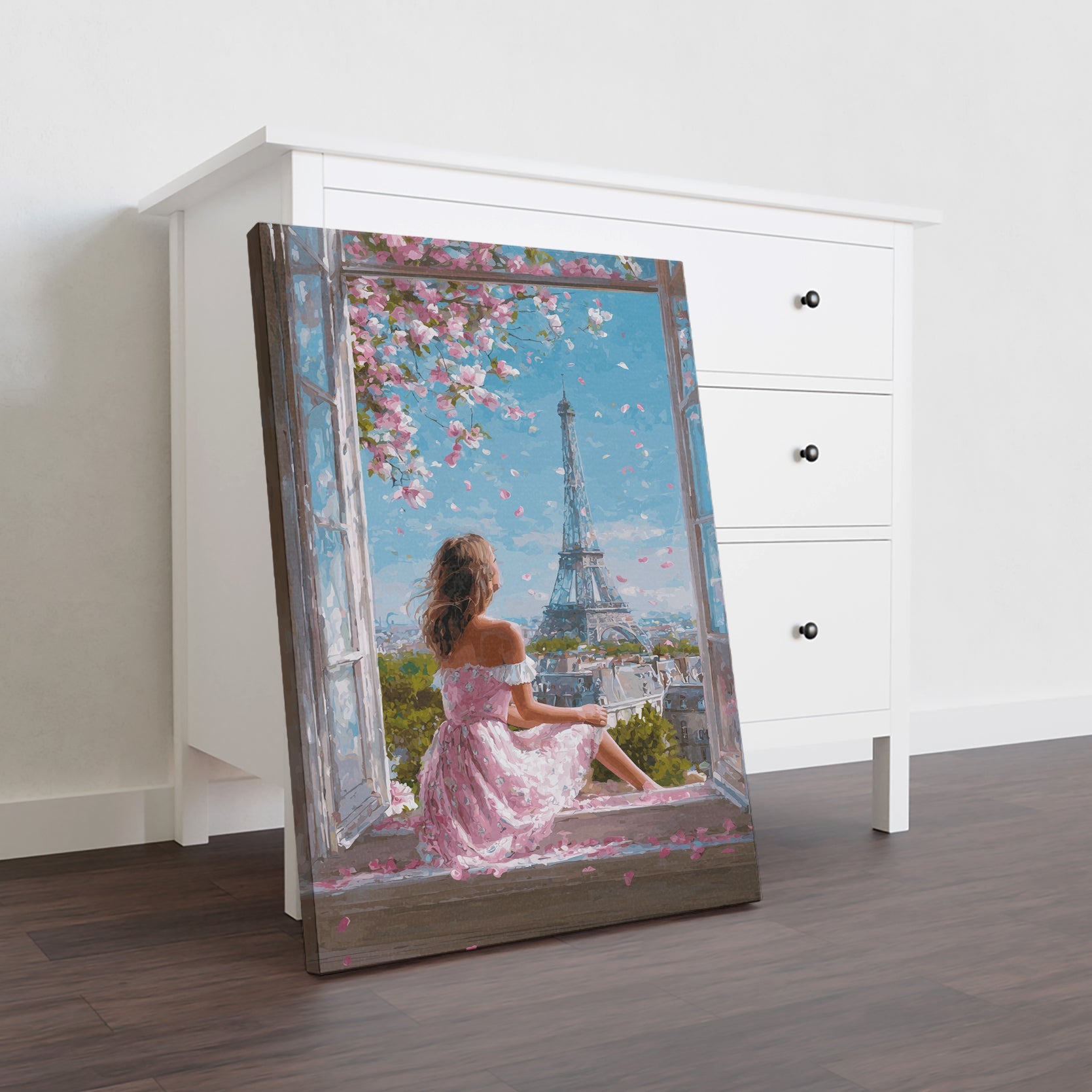 Transform your space with this enchanting canvas art featuring a romantic Parisian spring scene. The composition captures the iconic Eiffel Tower framed by delicate cherry blossoms in full bloom, creating a serene yet sophisticated aesthetic. Perfect for living rooms, bedrooms, or any area needing an elegant focal point, this piece brings timeless European charm and natural beauty into your home. The soft color palette and dreamy composition evoke tranquility while adding cultural sophistication to your déc