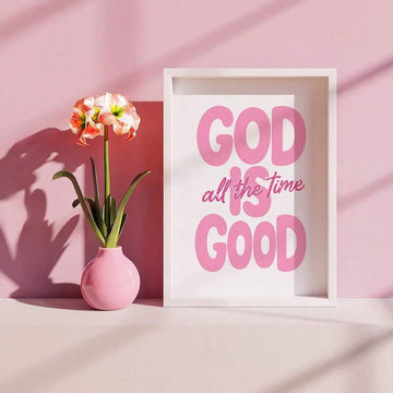 Pink God Is Good Christian quote print in white frame on styled shelf