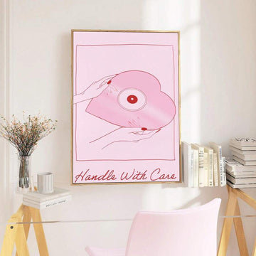 Pink heart-shaped vinyl record canvas poster held by hands with red nails