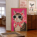 Tabby cat wearing sunglasses and a pink polka-dot scarf