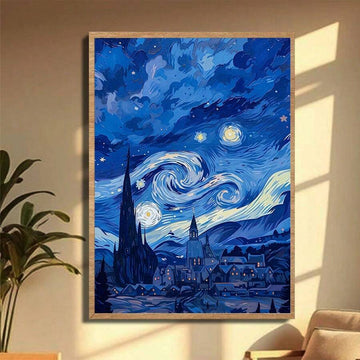 Framed swirling blue night sky and village canvas beside a leafy plant
