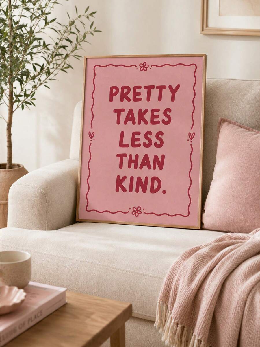 Pink framed quote print reading PRETTY TAKES LESS THAN KIND on cream sofa with pink pillow