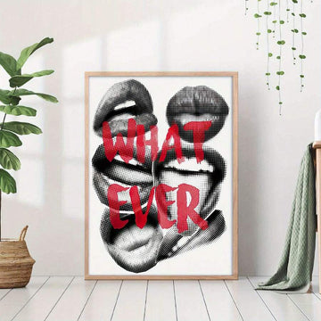 Large framed WHAT EVER lips poster on white floor with plants and throw nearby