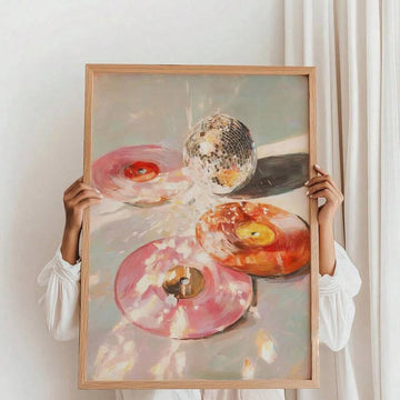 Portrait painting of pink and orange donuts with a mirrored disco ball held by a person