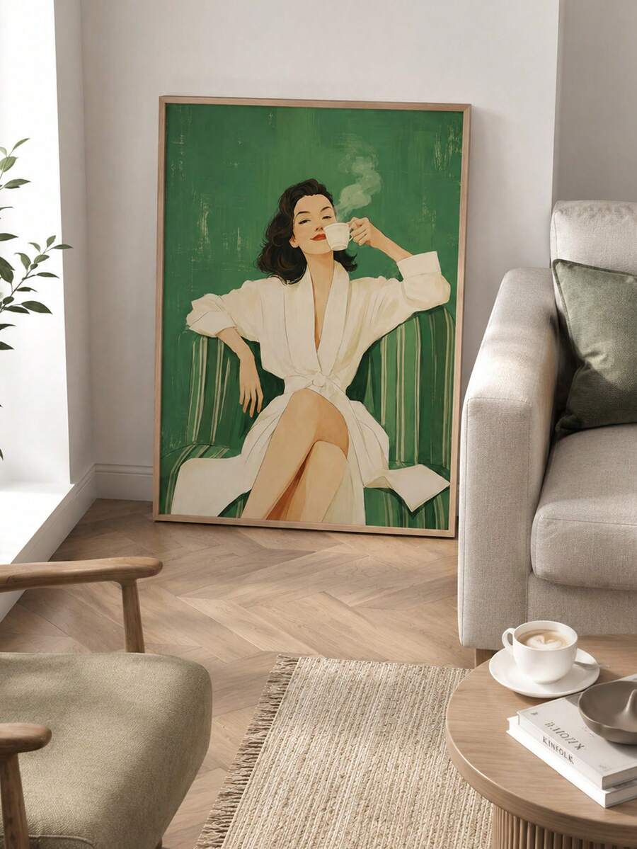 Large framed green portrait print leaning against living room wall beside beige sofa and coffee table