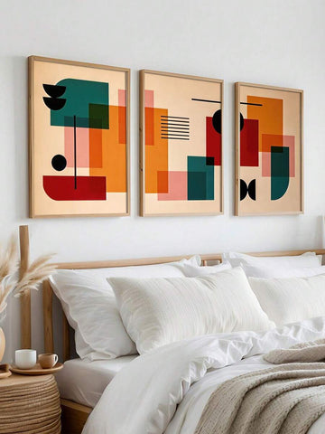 Three framed Bauhaus geometric posters above bed with white bedding