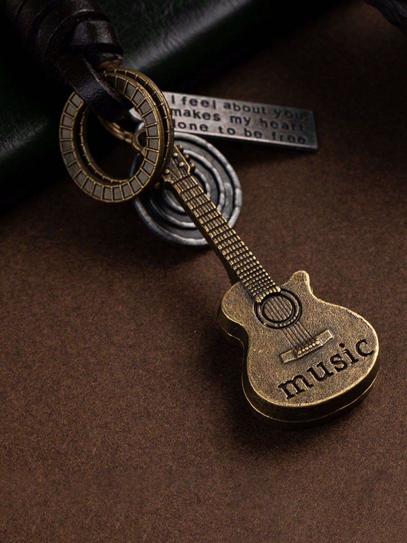 Add a touch of vintage charm to your keys with our Retro Guitar Cowhide Keychain. Handcrafted with stylish braided details, this keychain is perfect for any music lover. Made with durable cowhide for long-lasting use. Upgrade your key game today!