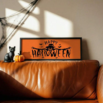 Happy Halloween pumpkin scarecrow artwork above a brown sofa with cat and pumpkin decor
