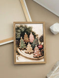 Framed holiday poster of decorated gingerbread tree cookies with evergreen branches and pinecones
