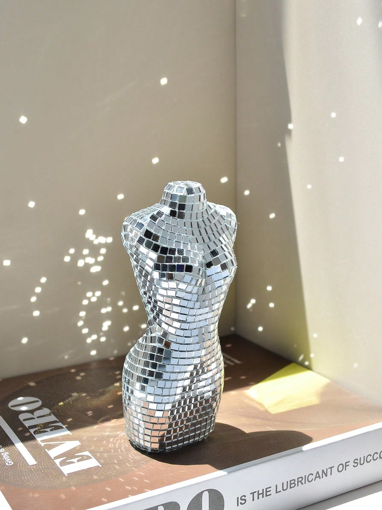 Add a touch of glamour to your holiday parties, dances, and weddings with our Shimmering Mini Disco Glass Mirror Mannequin Ornament. Beautifully crafted with reflective glass, this decorative piece will bring a festive sparkle to any event. Elevate your decor with this unique and versatile ornament.