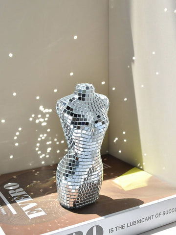 Add a touch of glamour to your holiday parties, dances, and weddings with our Shimmering Mini Disco Glass Mirror Mannequin Ornament. Beautifully crafted with reflective glass, this decorative piece will bring a festive sparkle to any event. Elevate your decor with this unique and versatile ornament.