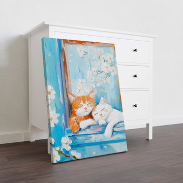 Transform your space with this captivating canvas wall art featuring serene sleeping cats rendered in rich oil painting style. The tranquil composition showcases feline subjects nestled against a soothing blue floral background, creating a harmonious blend of nature and comfort. Perfect for living rooms, bedrooms, or above sofas, this piece adds warmth and personality to any interior.