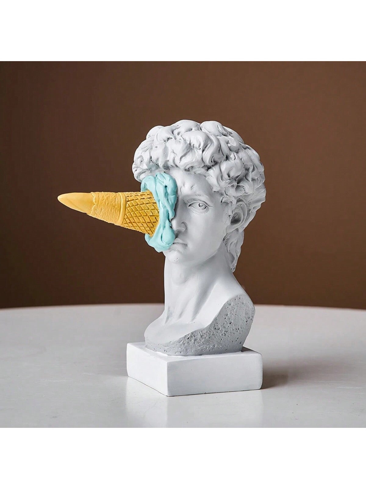 This small resin figurine depicts David enjoying an ice cream, making it a unique and charming gift for your loved ones. Crafted with high-quality resin, it adds a playful touch to any decorative display. Bring a smile to your loved ones' faces with this charming figurine.
