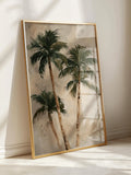 Large framed palm tree wall art leaning on sunlit floor with gold frame