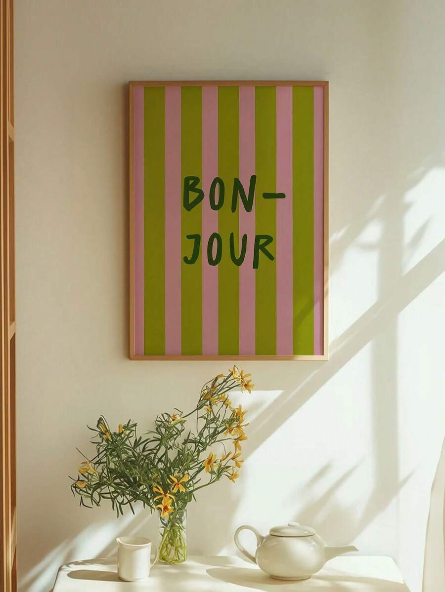 Add a touch of French elegance to your space with this modern "Bonjour" art print. Featuring striking pink and green stripes paired with contemporary typography, it's the perfect accent piece for bedrooms, living rooms, home offices, and beyond. The unframed design offers versatility—display it in a frame of your choice or use it as-is for a minimalist aesthetic. Ideal for those who appreciate chic, understated decor that brings personality and warmth to any room. A timeless addition to your home that celeb