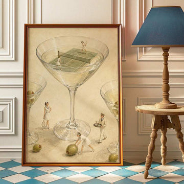 Framed surreal tennis print showing miniature players rallying inside an oversized martini glass among olives